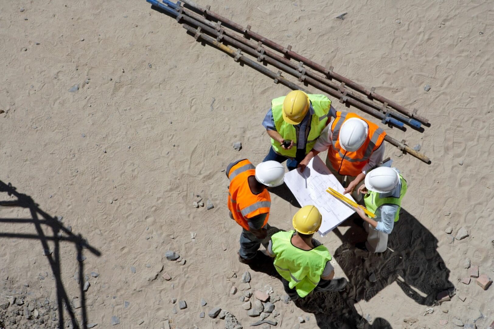 A group of construction workers standing around a table.